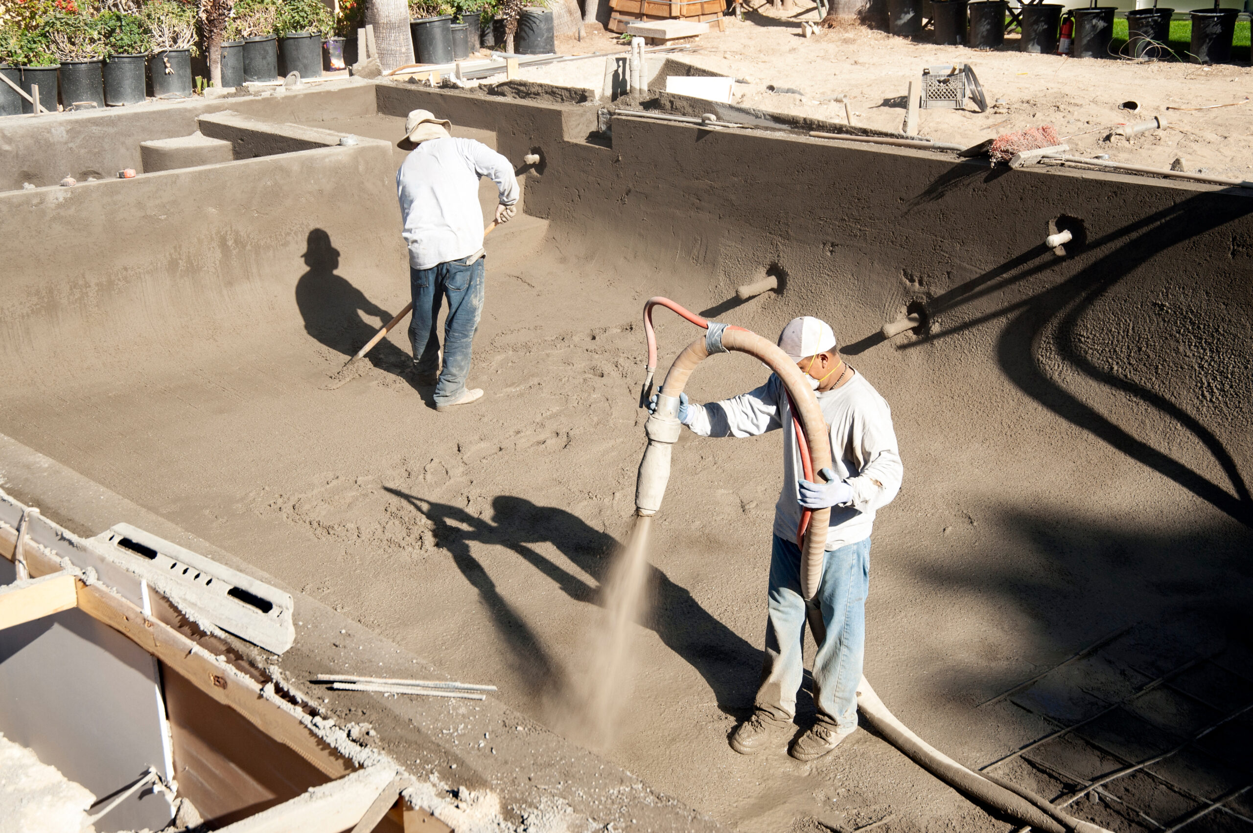 Spraying gunite on a new pool form